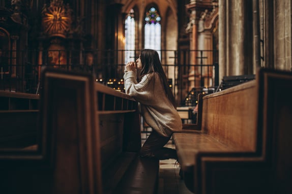 Young woman reciting prayers during Lent