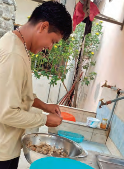 Man preparing food at a sink in Ecuador