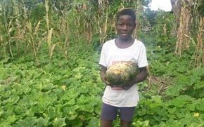 student with vegetable