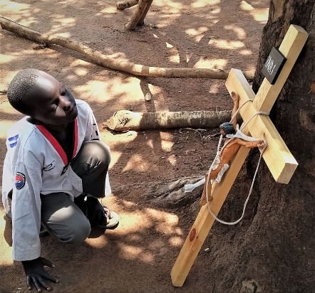 child admiring crucifix