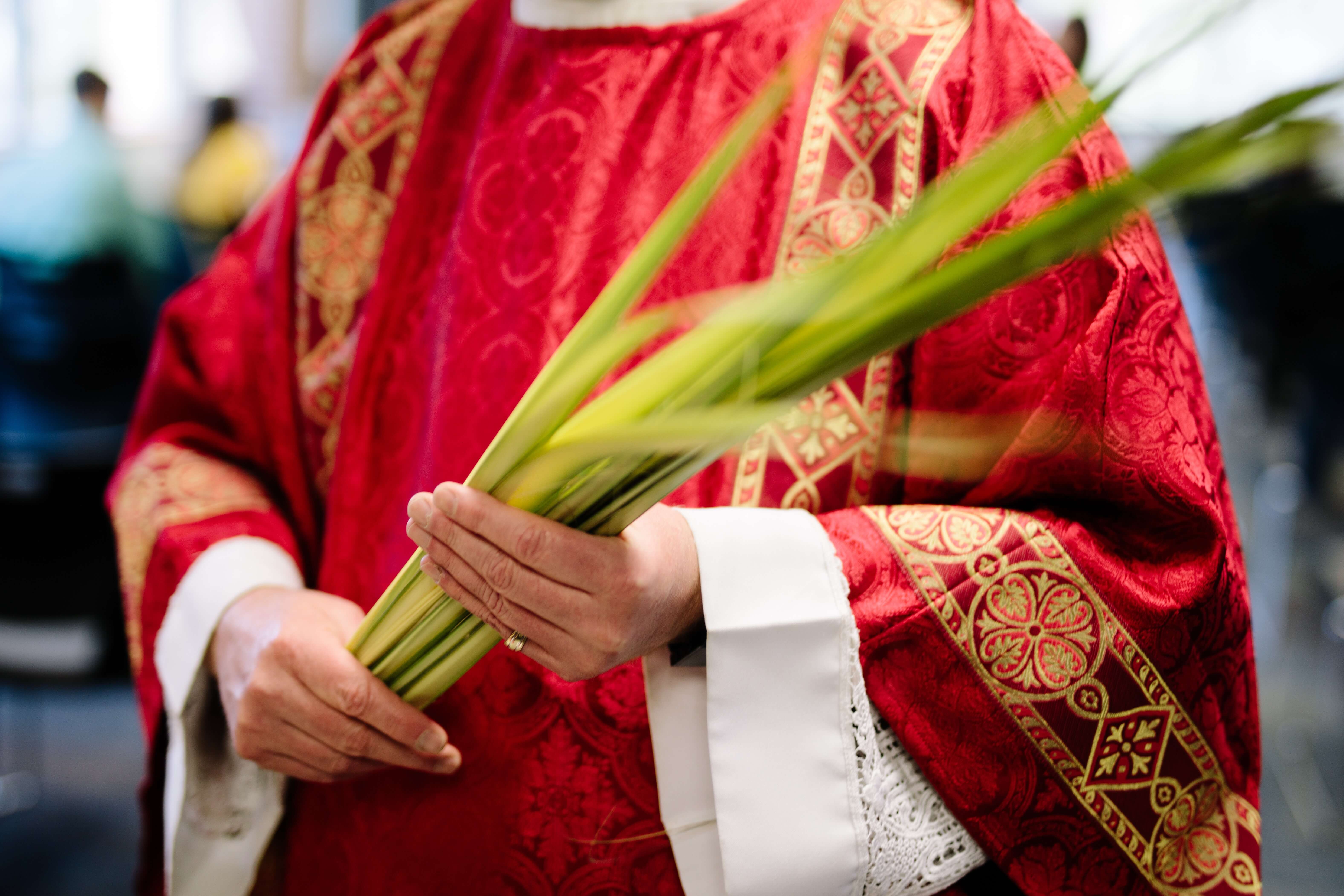 Priest holds palms on Palm Sunday